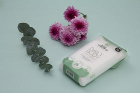 DAILY CONCEPTS scrubber staged in serene bathroom setting with towels — presents sustainable lifestyle benefit
