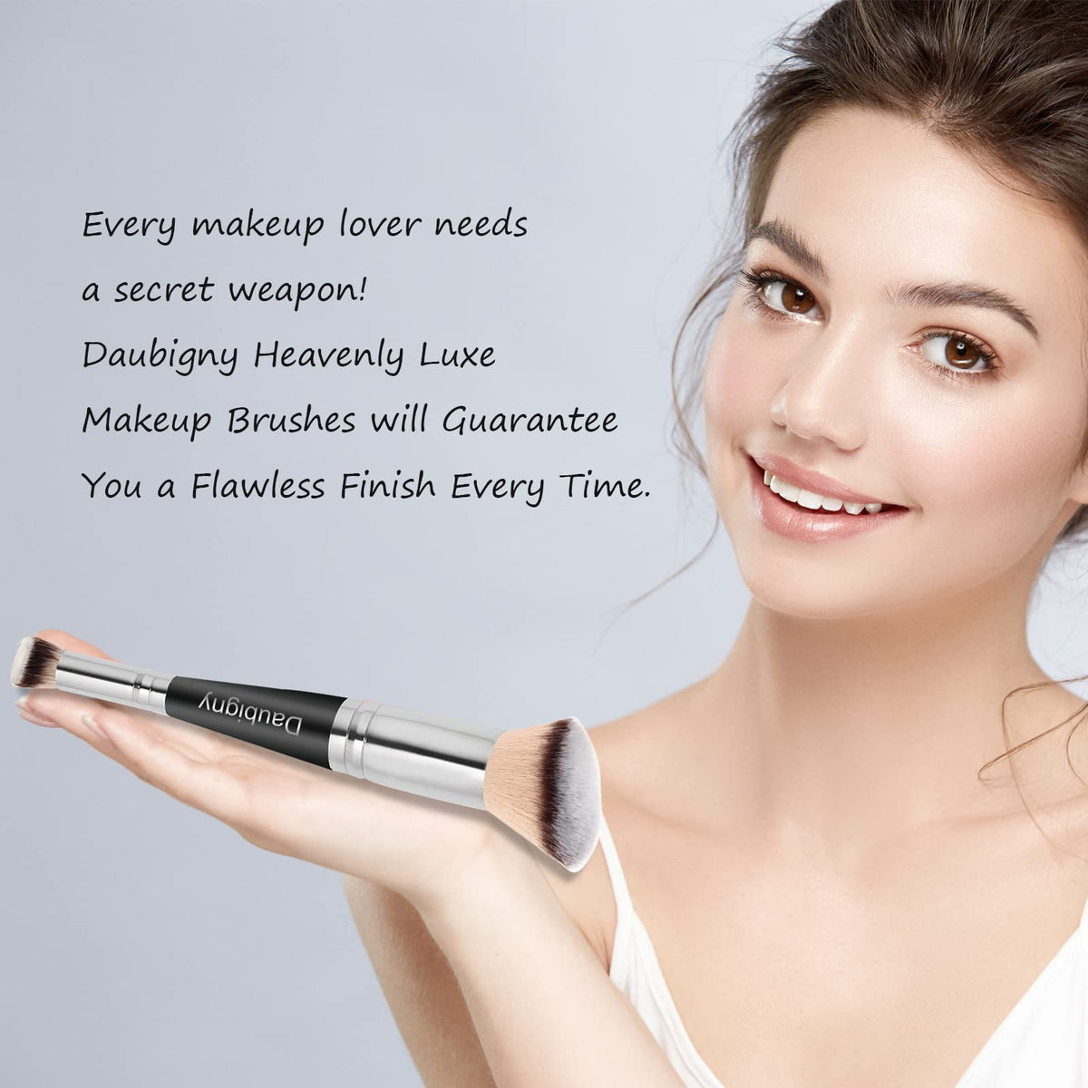 Daubigny brush held in hand to show scale and travel-friendly compact design benefit