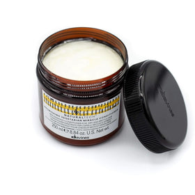 Davines applying conditioner to mid-lengths and ends to improve detangling