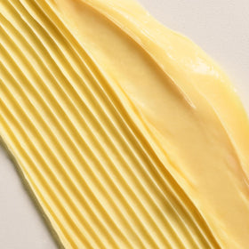 Applying Davines DEDE to hair mid-lengths for detangling and softness benefit