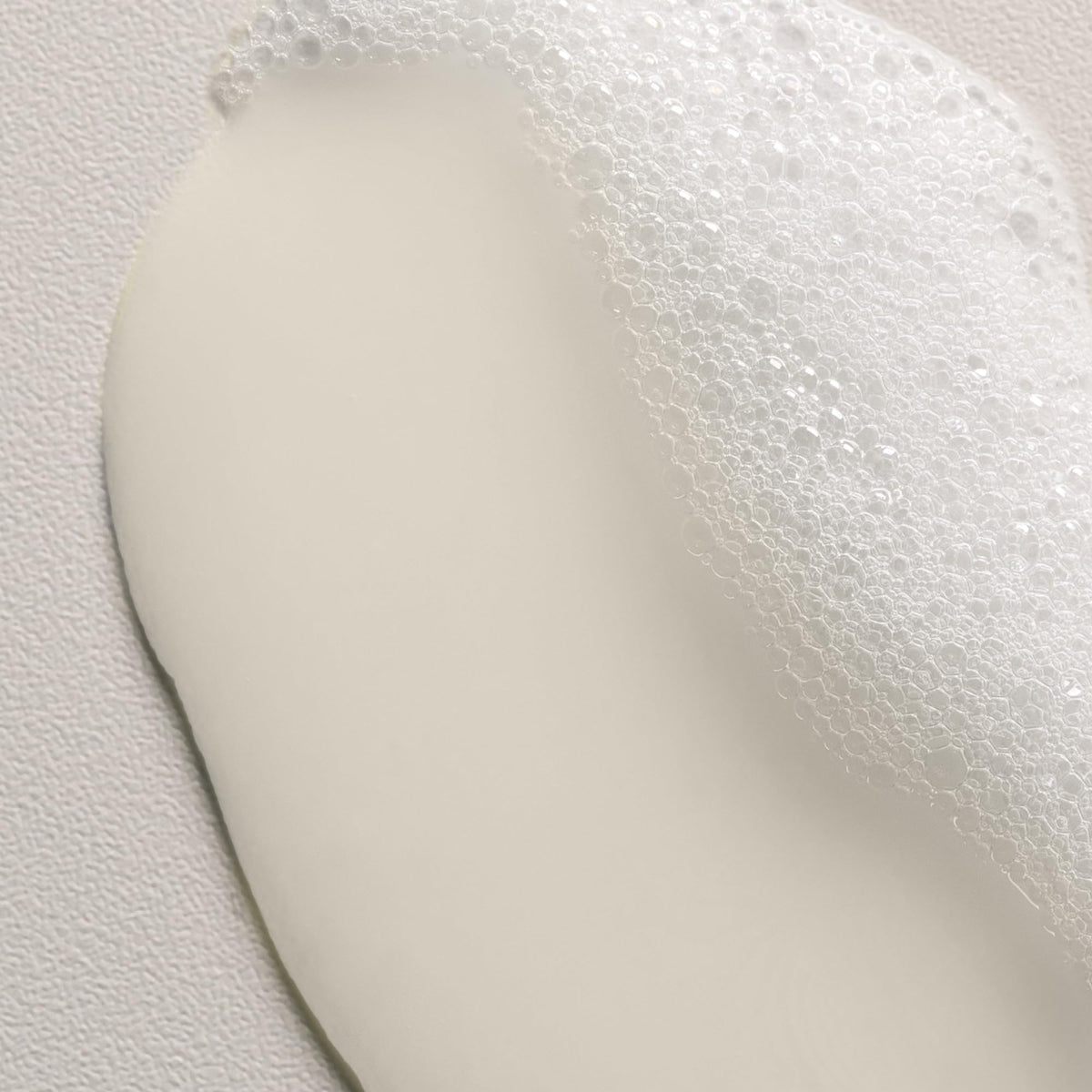 Wet curly hair being washed with Davines shampoo showing enhanced curl definition