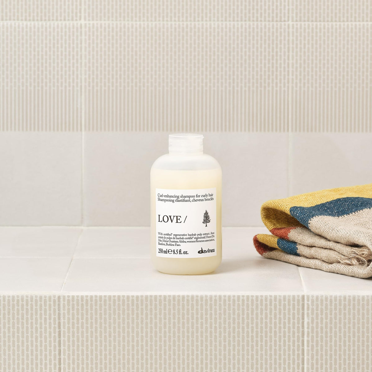 Baobab fruit next to Davines bottle illustrating regenerative ingredient benefit