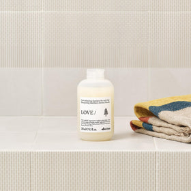 Baobab fruit next to Davines bottle illustrating regenerative ingredient benefit