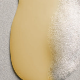 Hand applying Davines NOUNOU shampoo demonstrating easy application