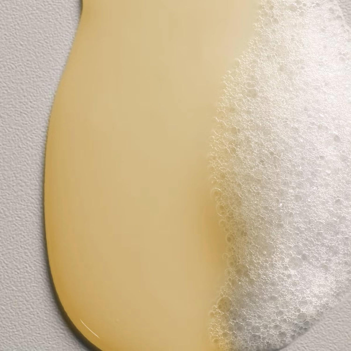 Davines NOUNOU bottle held in hand to show scale and portability