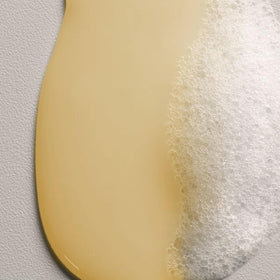Davines NOUNOU bottle held in hand to show scale and portability