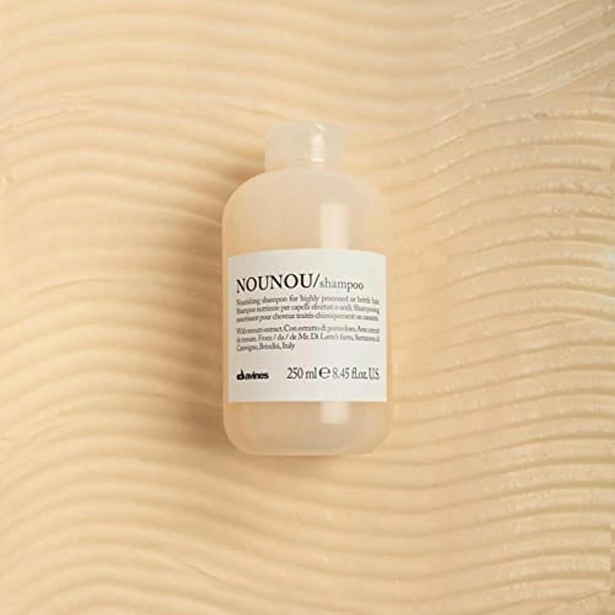 Davines NOUNOU pump and cap close-up highlighting easy dispensing