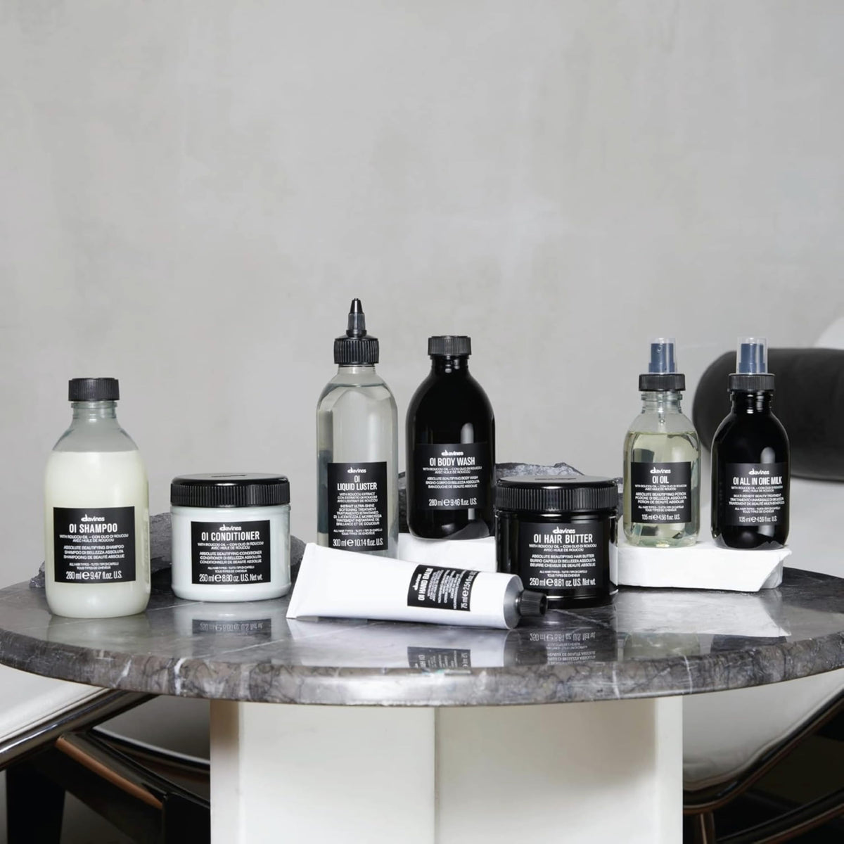 Hand holding Davines 8.45 fl oz jar to show scale and convenience