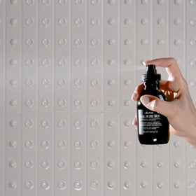 Davines OI product in use smoothing hair showing reduced frizz and glossy finish benefit