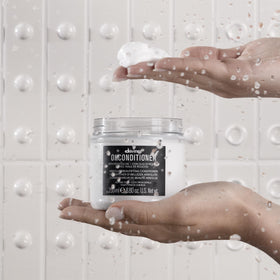 Davines OI milk dispensing pump shot showing easy application with protective layer benefit