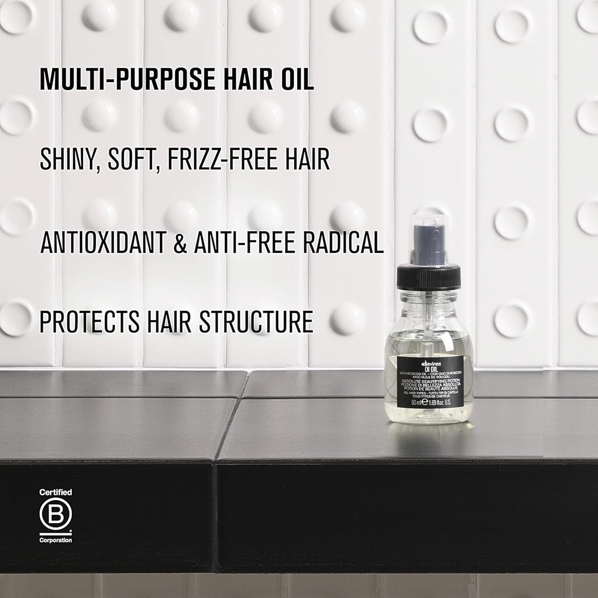 Davines OI Oil next to a coin for size comparison ideal for travel benefit
