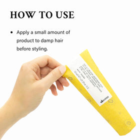 Applying Davines fluid to towel-dried hair to improve manageability and reduce frizz