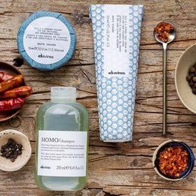 Davines product held in hand for scale showing compact travel-friendly benefit