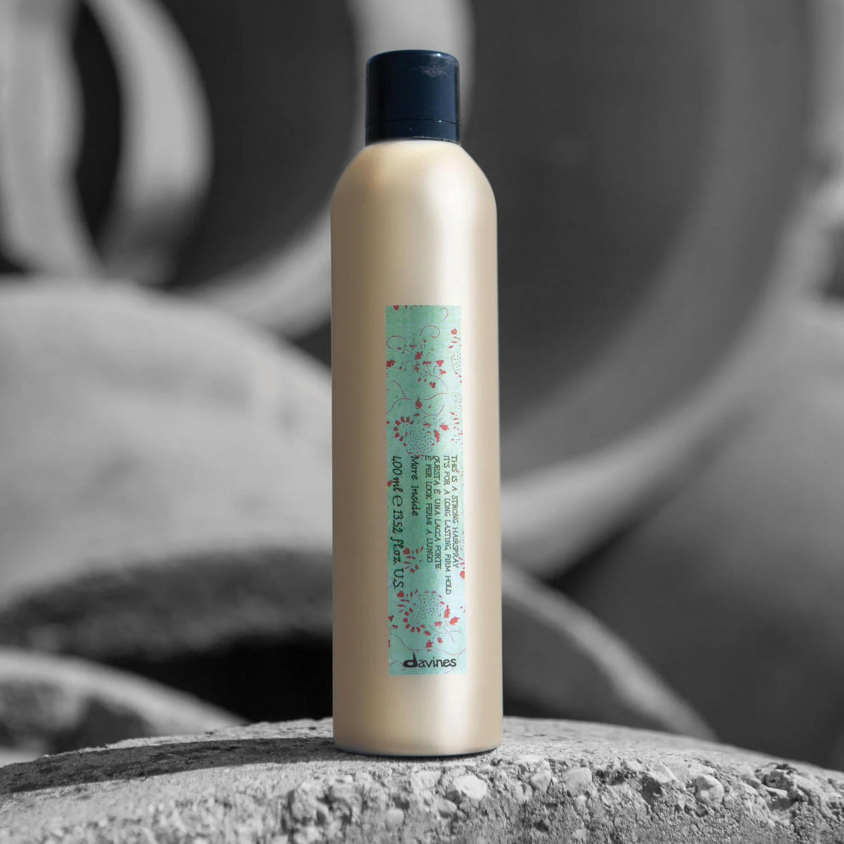Davines spray nozzle close-up revealing fine mist delivery for even hold