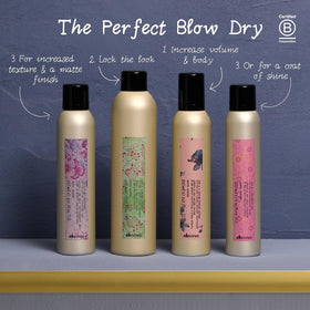 Davines can next to hand to show 13.53 fl oz scale and portability