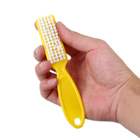 DAYGOS brush next to a coin to show compact size and easy handling