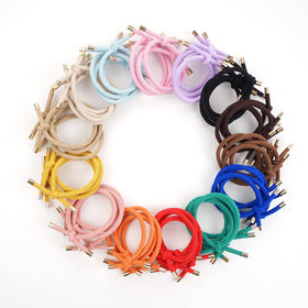 DealEachDay hair ties next to a hand for size comparison and easy-carry benefit