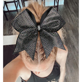 DEEKA bow next to ruler showing 8-inch scale for visual sizing
