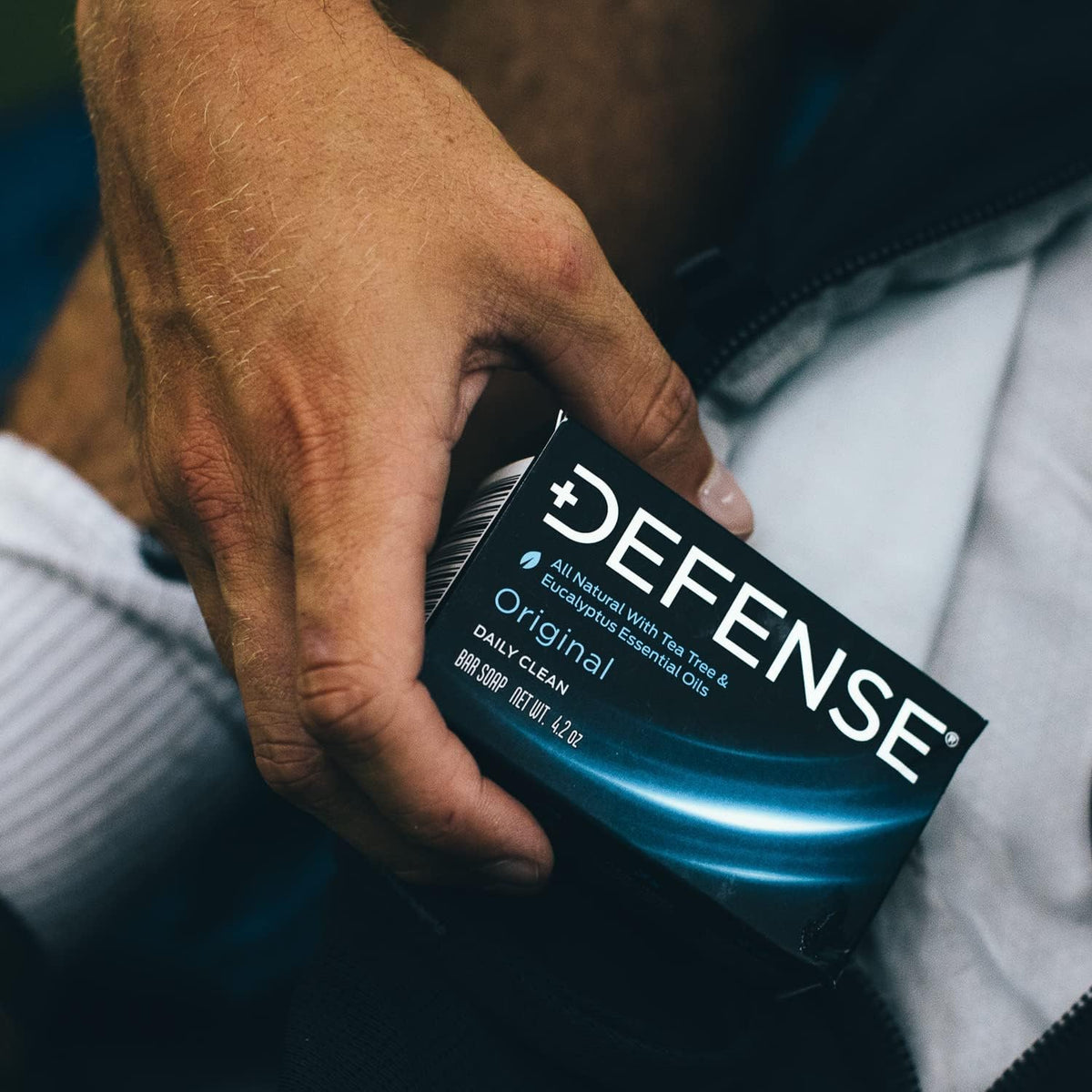 Defense Soap bar next to coin for scale indicating compact, travel-friendly size