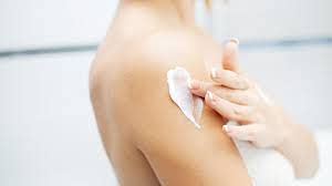 Del Indio Papago applying cream to arm to demonstrate targeted moisturization
