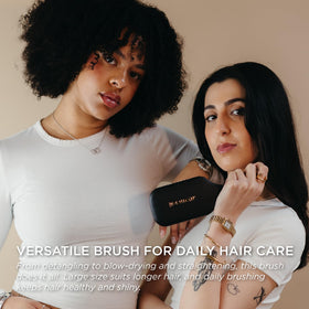 Denman brush held in hand to show size and balance benefit