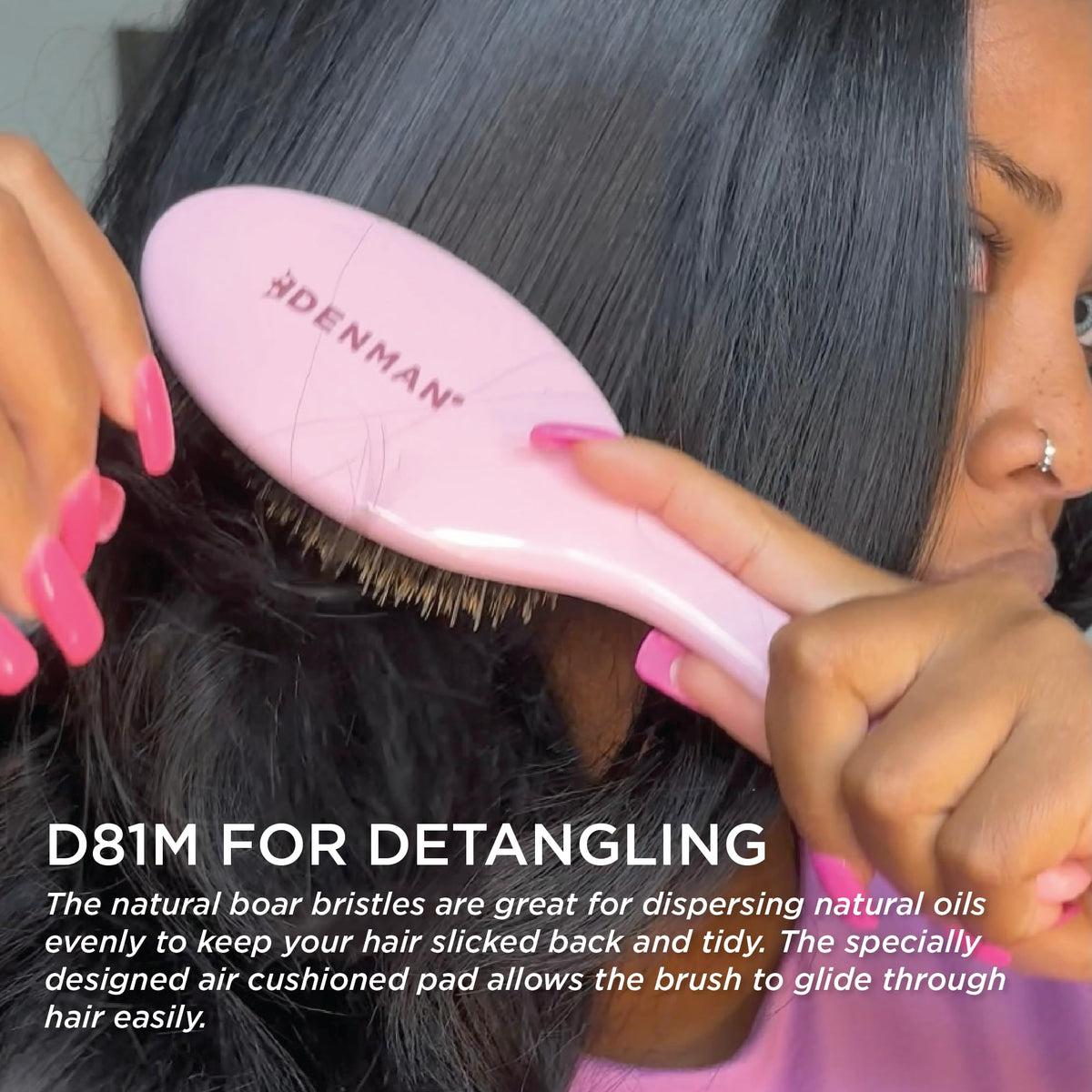 Hand holding Denman D81M to show size and ergonomic grip for comfortable daily brushing