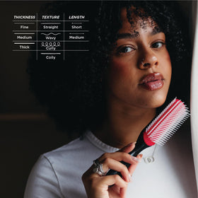 Lifestyle shot of Denman brush near styling products conveying salon-quality results
