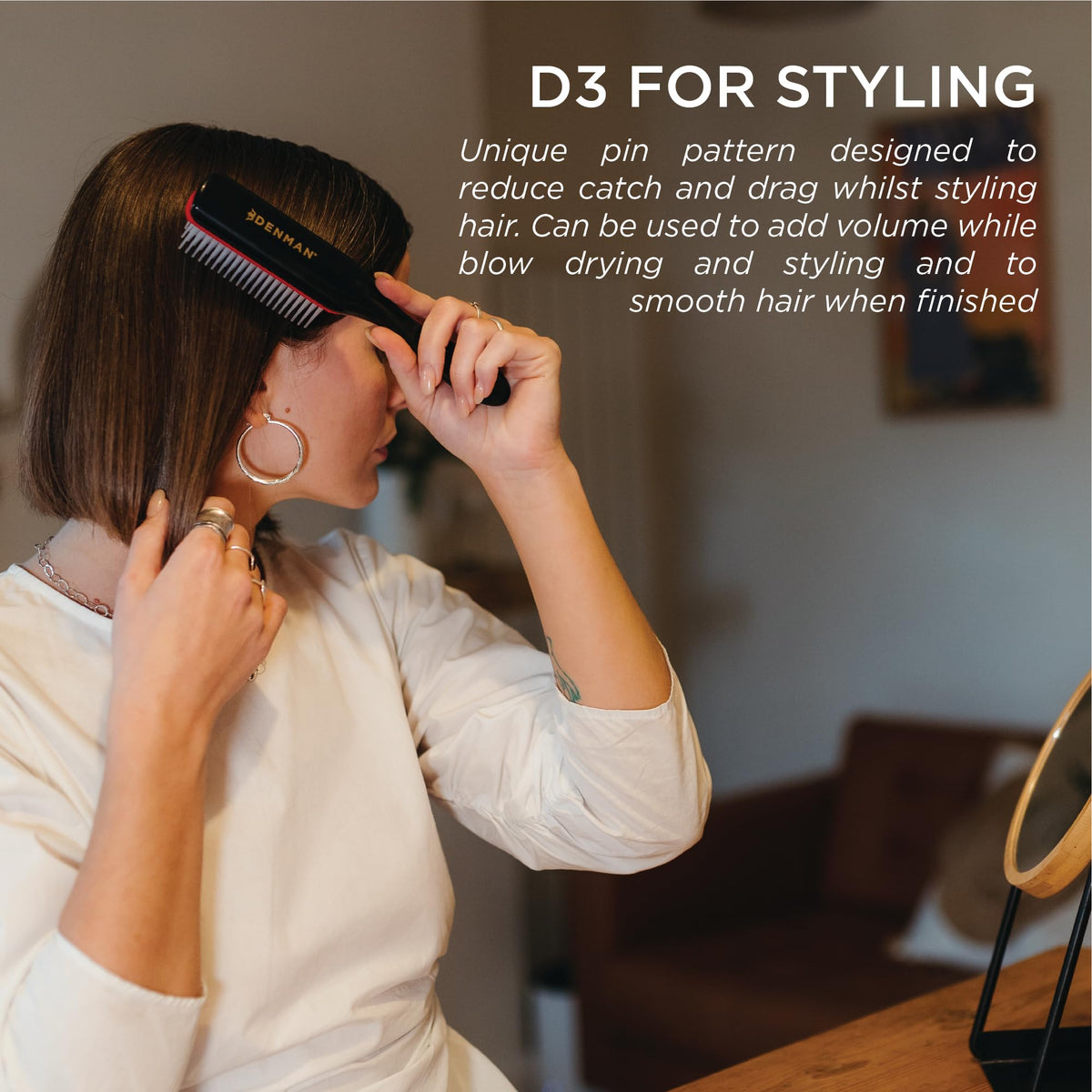Denman brush being used on damp hair to shape and define curls with tension