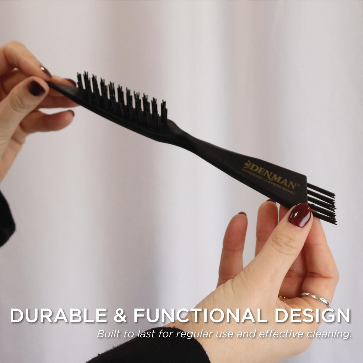 Denman DBC1 in use removing hair from a paddle brush for faster maintenance