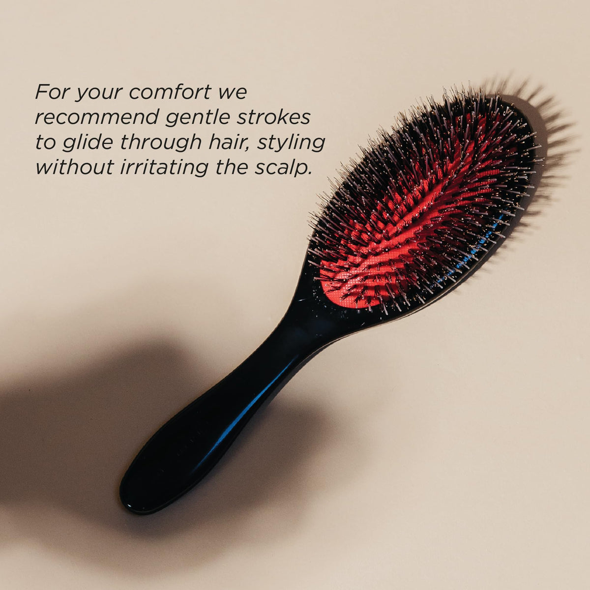 Denman brush styling a slick-back look, creating smooth flyaway-free finish