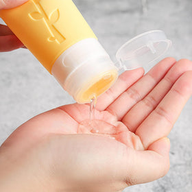 DEPOZA bottles next to a coin showing compact travel-friendly scale