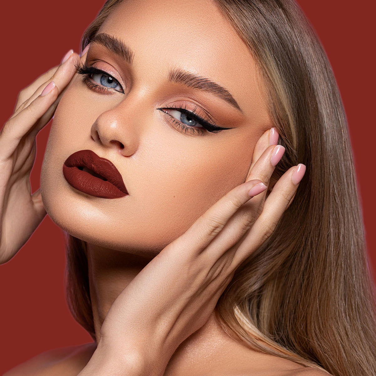 Depuplum DM18 swiped on model lips showing rich oxblood color and long‑wear matte effect