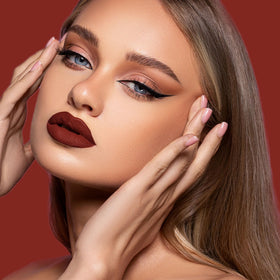 Depuplum DM18 swiped on model lips showing rich oxblood color and long‑wear matte effect
