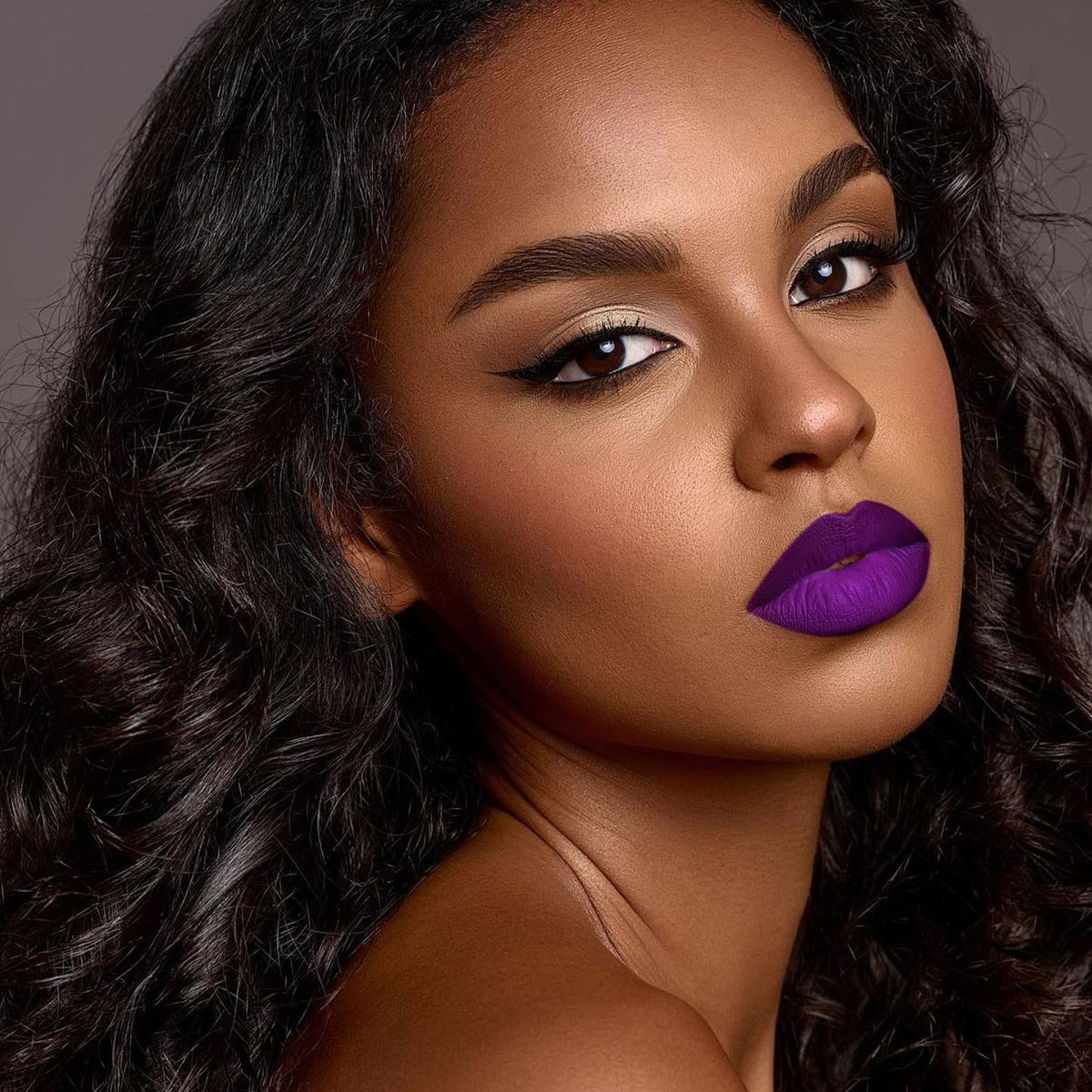 Depuplum DM22 swatch on arm showing rich purple pigment and long-lasting payoff