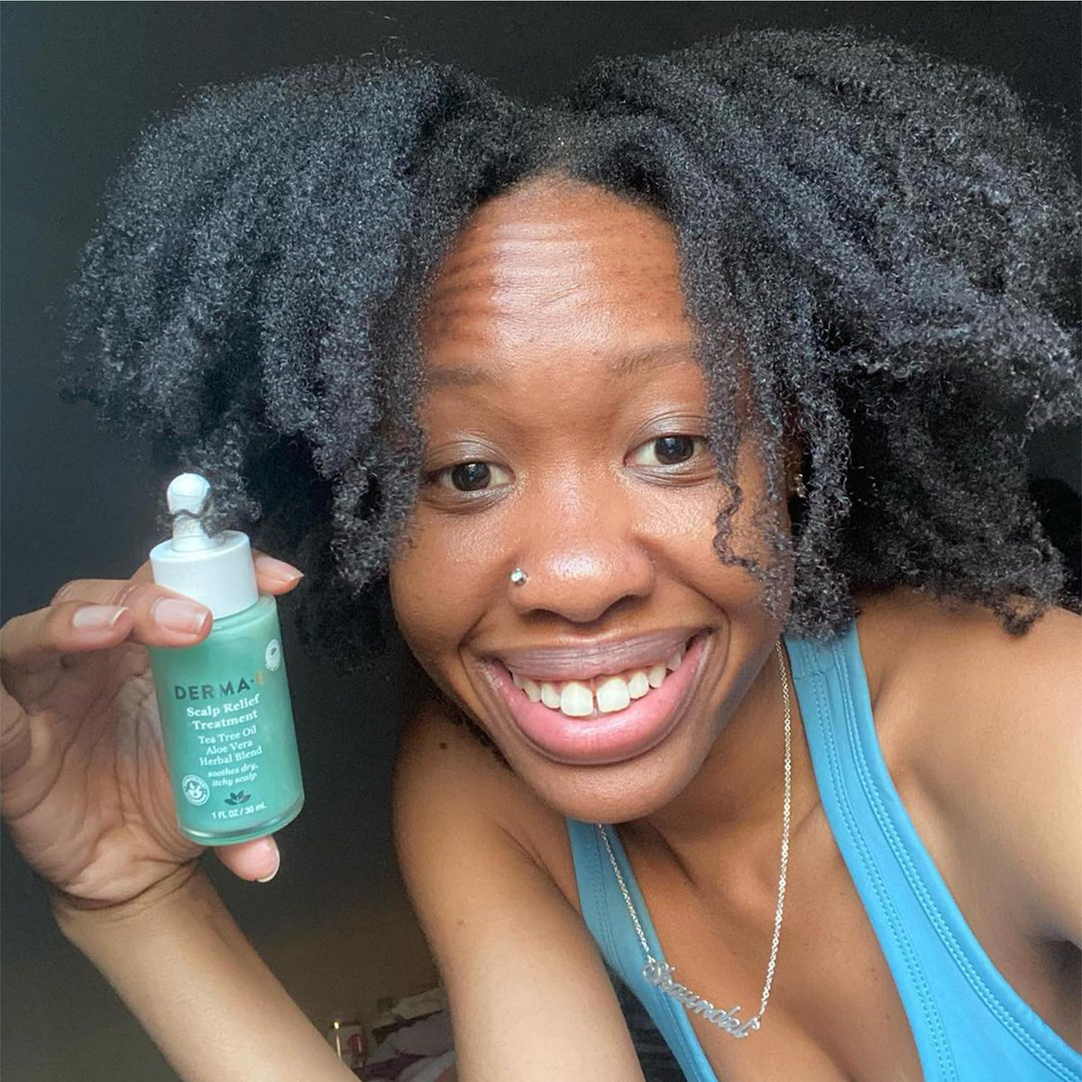 Derma E bottle in hand for scale showing compact 1 fl oz convenience