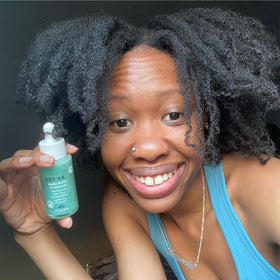 Derma E bottle in hand for scale showing compact 1 fl oz convenience