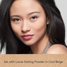 Dermablend powder being picked up with brush for seamless mattifying application benefit