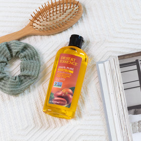 Desert Essence jojoba oil droplet on hand illustrating quick absorption