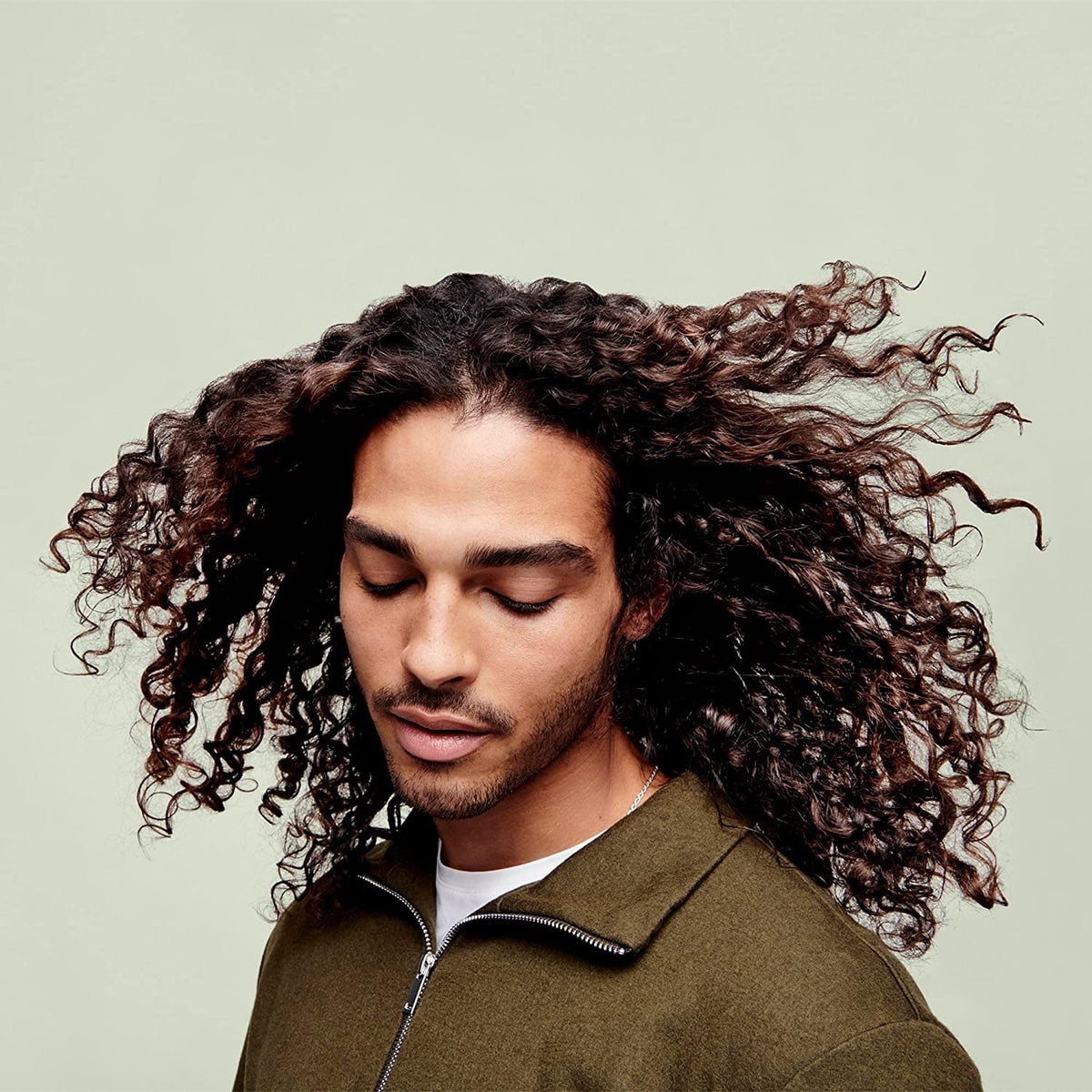 DevaCurl being applied to wet curls in shower, helping detangle and reduce frizz