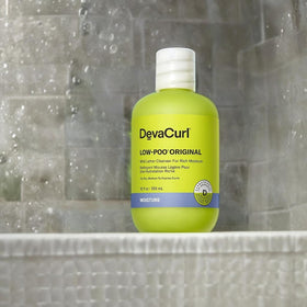 DevaCurl Low-Poo Original in shower being applied for gentle cleansing