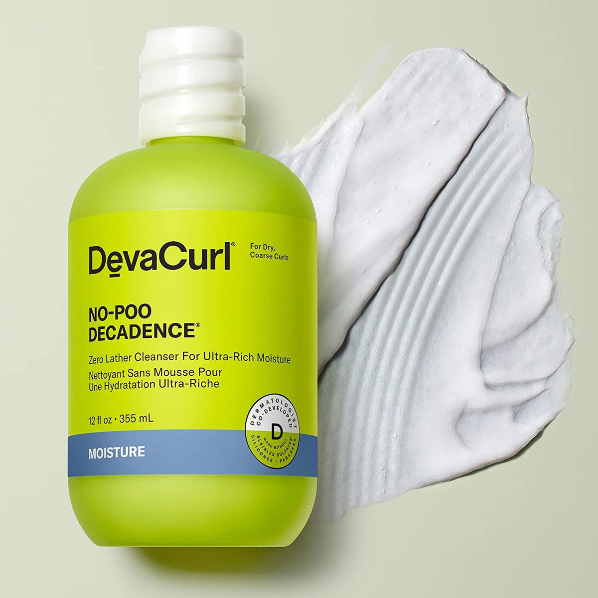 DevaCurl creamy cleanser texture on hand, demonstrates slip for detangling