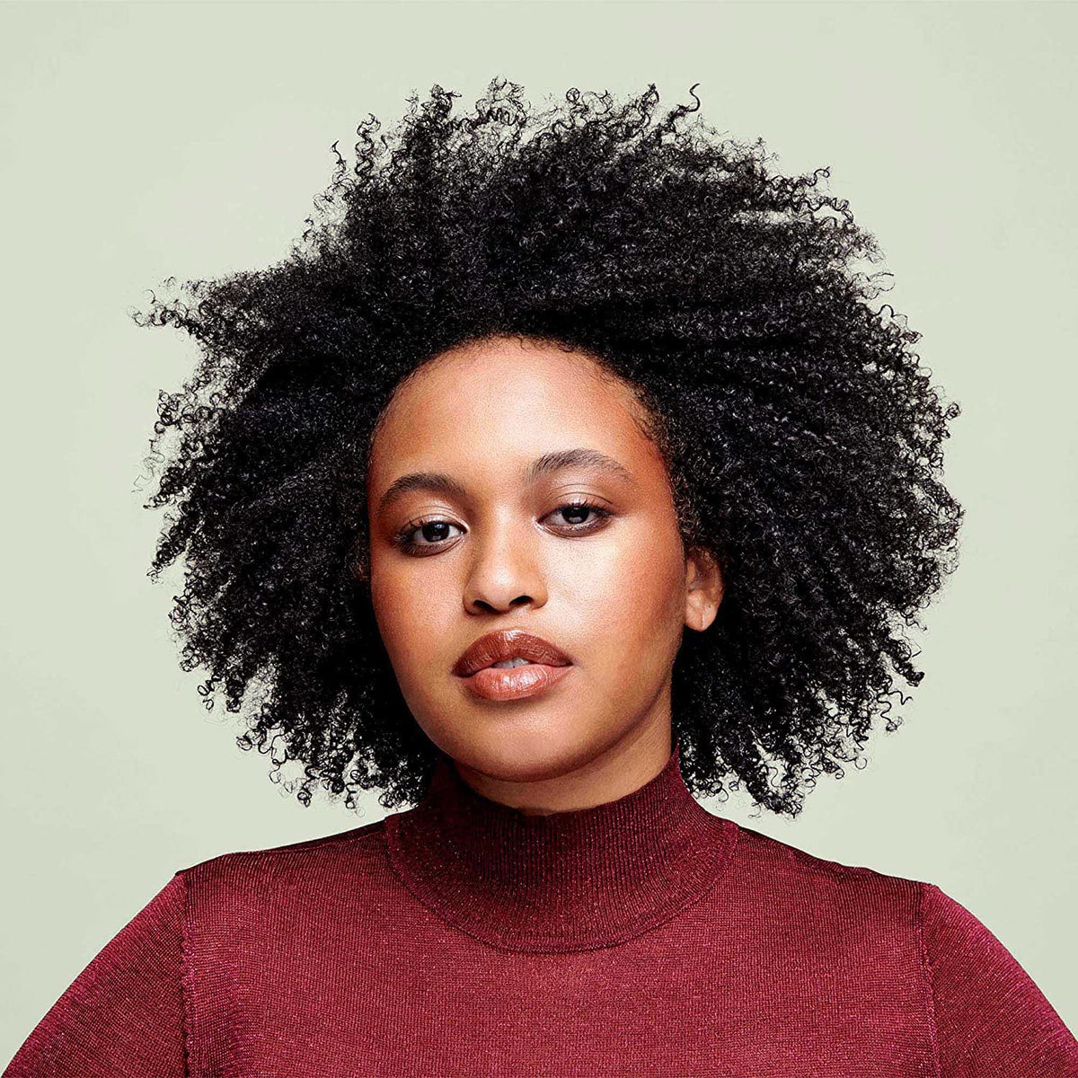 DevaCurl dispensing cleanser from bottle, shows easy application and control