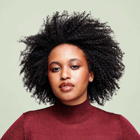 DevaCurl dispensing cleanser from bottle, shows easy application and control