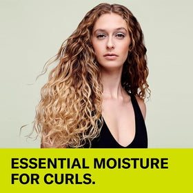 DevaCurl poured texture on palm showing creamy, non-lathering formula benefit