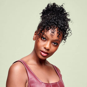 DevaCurl hairspray applied on curly hair reducing frizz and adding shine