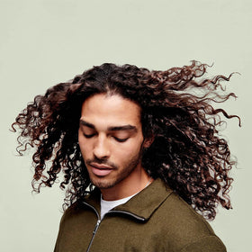 DevaCurl ingredients label close-up featuring chufa milk and quinoa protein benefits