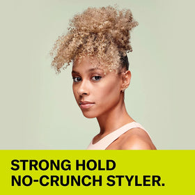 DevaCurl product held in hand for scale showing 12 fl oz size and travel-friendly benefit