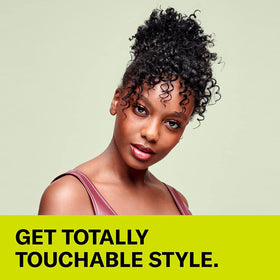 DevaCurl cream in hand being applied to hair demonstrating easy spread and slip benefits
