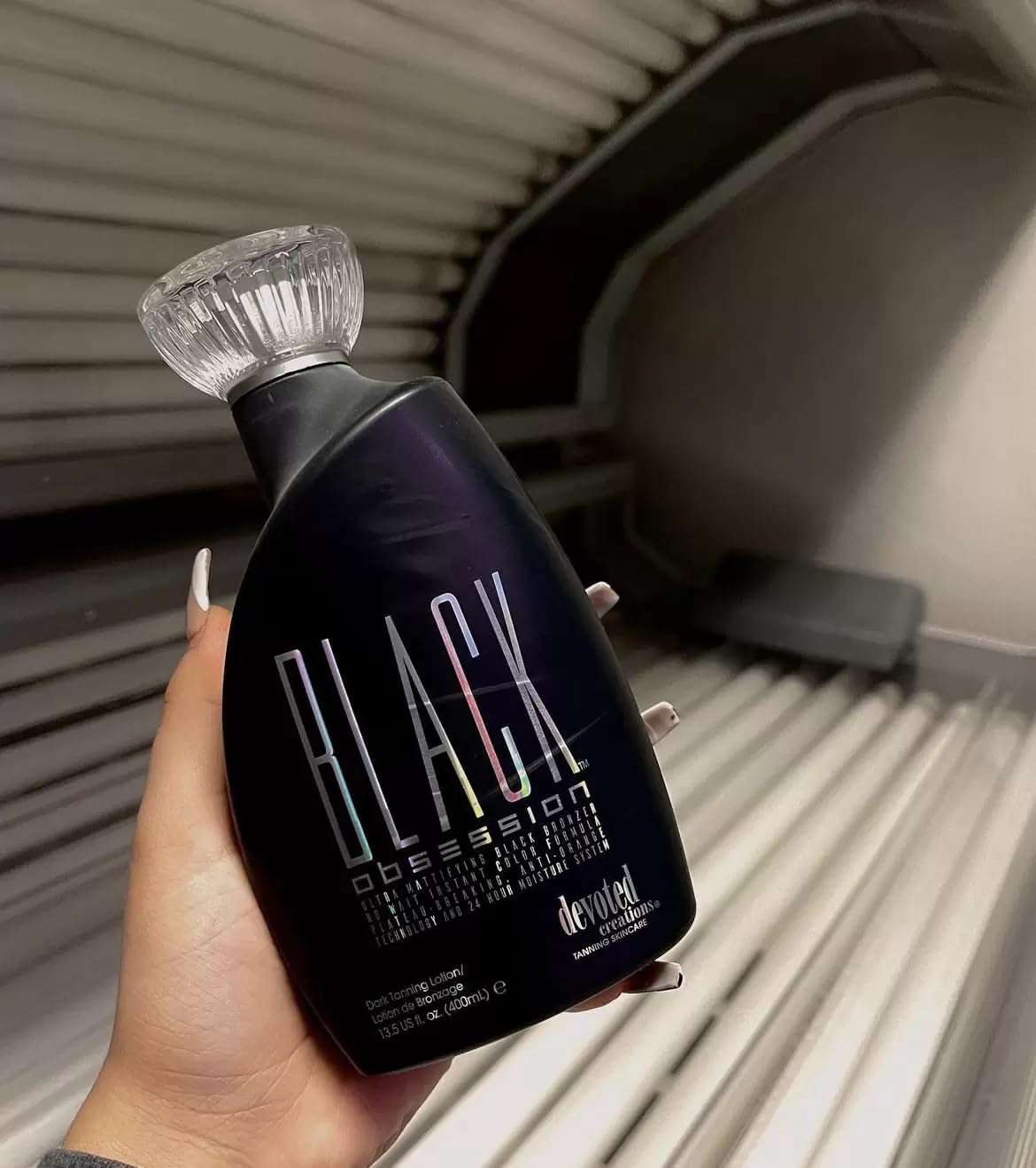 Devoted Creations bottle with ingredient callouts highlighting key skin-care benefits