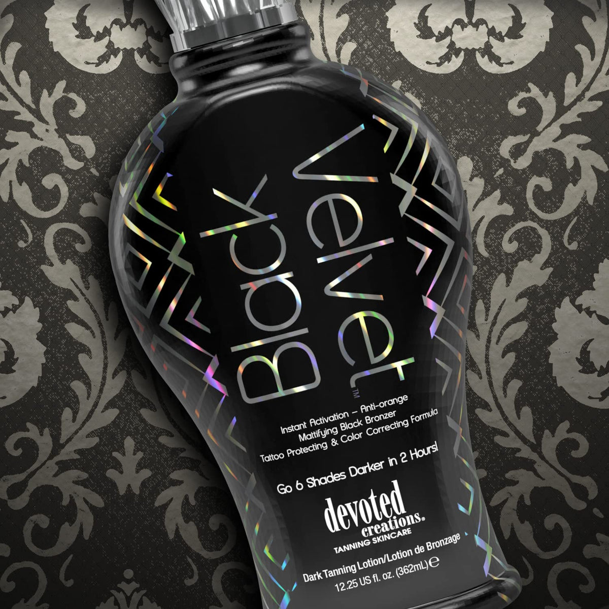 Devoted Creations bottle next to hand for scale, indicates travel-friendly 12.25 oz size
